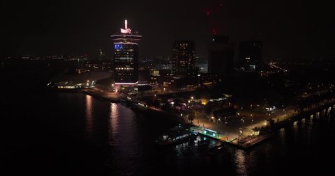 Amsterdam, 13th of November 2021, The Netherlands. Amsterdam Lookout tower at night. Ferries next to the tower.