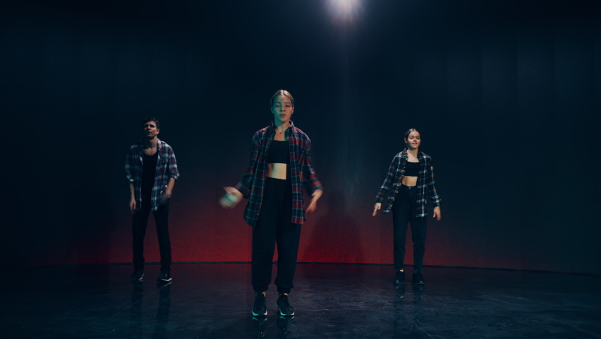 Diverse Group of Three Professional Dancers Performing a Hip Hop Dance Routine in Front of a Big Led Wall Screen with VFX Animation During a Virtual Production in Studio Environment. 105 BPM Song. Royalty-Free Stock Footage #1084666582
