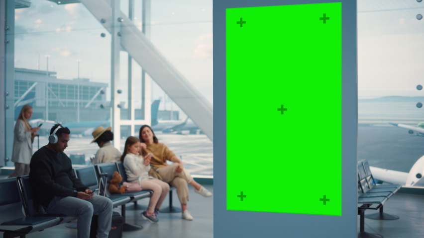 Airport Terminal: Green Screen Advertising Billboard, Arrival Display with Chroma Key, Mock-up AD Space. Backgrond: Diverse Crowd of People Wait for their Flights in Boarding Lounge of Airline Hub | Shutterstock HD Video #1084670509