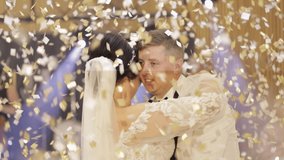 Newlyweds dance. Lovely Caucasian bride and groom dancing first at the wedding party. Falling confetti. Embracing, huggings. Happy family couple. Man and woman in love. Bride in gorgeous wedding dress - Powered by Shutterstock - Get 15% off with code: PIKWIZARD15