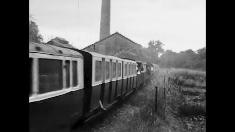 Kent, England, 1970 - Romney Hythe and Dymchurch narrow gauge train runs through countryside full of passengers