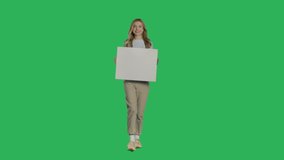 Young caucasian woman holding a blank white sign on a Green Screen, Chroma Key. 4k UHD front view isolated video - Powered by Shutterstock - Get 15% off with code: PIKWIZARD15