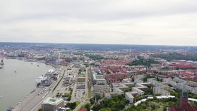 Inscription on video. Gothenburg, Sweden. Panorama of the city and the river Goeta Elv. The historical center of the city. Cloudy weather. Heat burns text, Aerial View