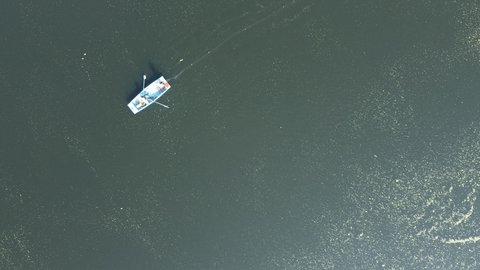 Aerial view of fishermen in a small boat at the confluence of rivers Bhima and Indrayani at Tulapur near Pune India.