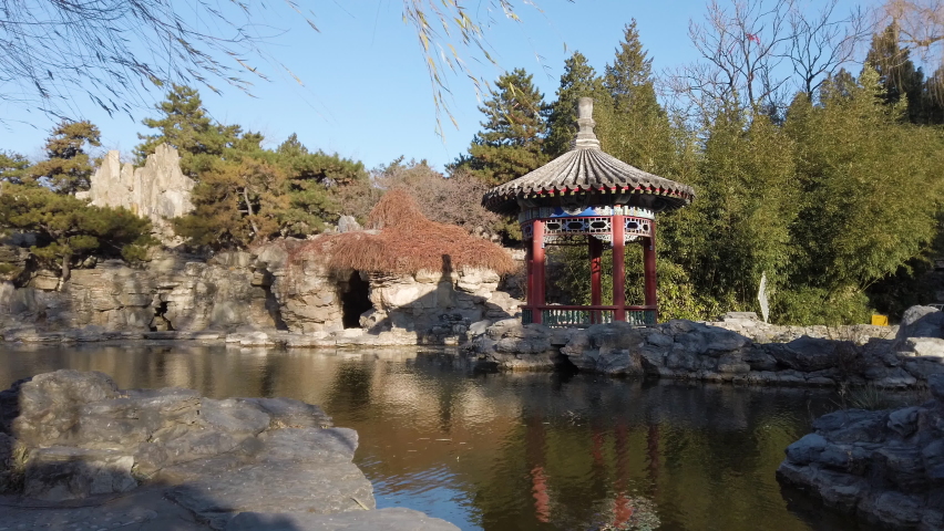 Chinese pavilion by the lake in Ritan Park in windy autumn,Beijing,China