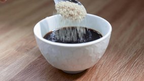 Close up hand pours sugar into her coffee cup - Powered by Shutterstock - Get 15% off with code: PIKWIZARD15