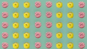 Colorful pattern of donuts isolated on green background. Seamless pattern with donut. Doughnuts. Top view. Realistic animation. 4K video motion