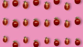 Colorful pattern of fresh red tomatoes on pink background. Seamless pattern with cherry tomato. Realistic animation. 4K video motion