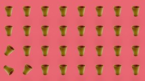 Colorful pattern of paper drinking cups on pink background. Seamless pattern with paper cup. Top view. Realistic animation. 4K video motion