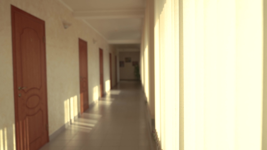empty hotel corridor into the coronavirus a pandemic. bankruptcy of hostel hotel in coronavirus no people losses. empty corridor in hallway hotel doors to rooms light from window view inside hostel