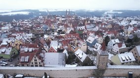 DRONE AERIAL FOOTAGE: Rooftops with snow in Rothenburg ob der Tauber, Bavaria. Rothenburg is one of the famous tourist attractions in Germany. It’s well known for its well-preserved medieval old town.