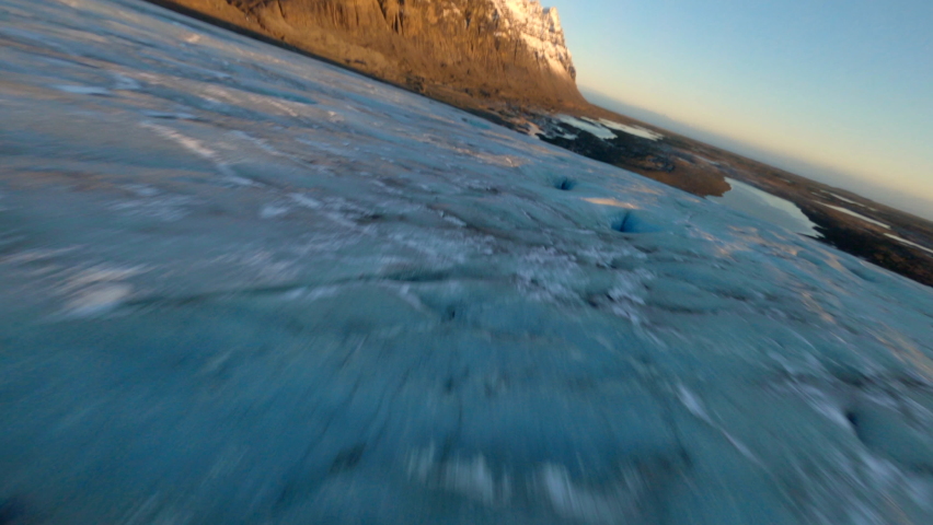 Aerial view of man walking at glacier skaftafell, Vatnajökull National Park. Iceland