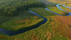 Majestic aerial footage of a winding river at dawn. Bird's eye view. Location place Polissya region, Ukraine, Europe. Cinematic drone shot. Filmed in UHD 4k video. Discover the beauty of earth.