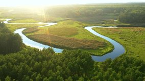 Fantastic aerial footage of a winding river at dawn. Bird's eye view. Location place Polissya region, Ukraine, Europe. Cinematic drone shot. Filmed in UHD 4k video. Discover the beauty of earth.