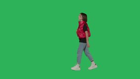 Teen girl with basketball walking on Green Screen, Chroma Key. Side view 4k uhd video footage