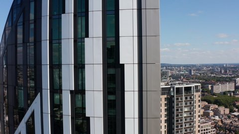 Orbiting around Strata tall apartment building. Modern design facade of skyscraper closeup. London, UK