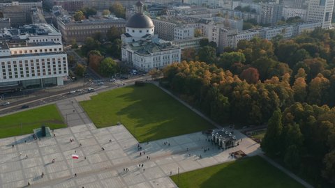 High angle view of Pilsudski Square corner with surviving part of Saxon Palace. Revealing church with dome and downtown high rise buildings. Warsaw, Poland