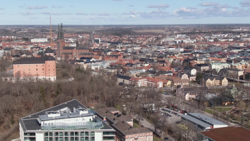Aerial shot panning across Uppsala city with Cathedral and Castle in Sweden
