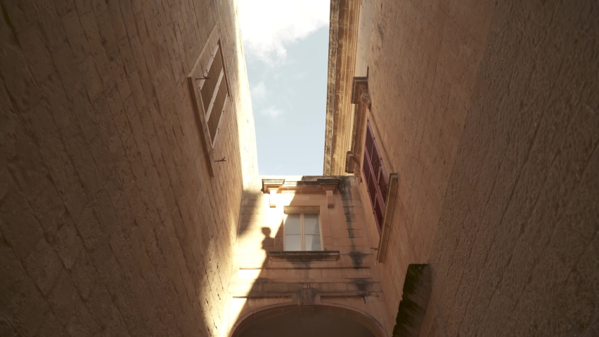 Tall Ancient Old Building Walls with Passage Connecting Two Houses in Mdina