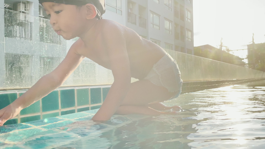 Happy asian boy practice swim in swimming pool sport recreation