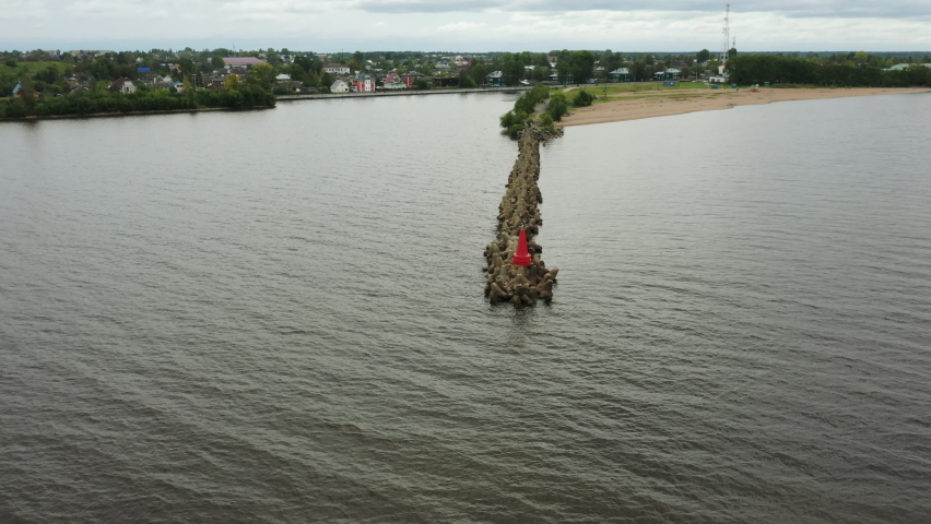 Breakwater. Sea waves crashing on the tetrapod pier. Bird