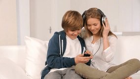 Teenagers listening to music at home 