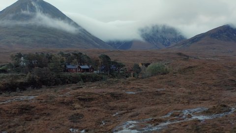 Aerial drone view of Sligachan in Isle of Skye, mountains with cloud around them on a cold foggy morning