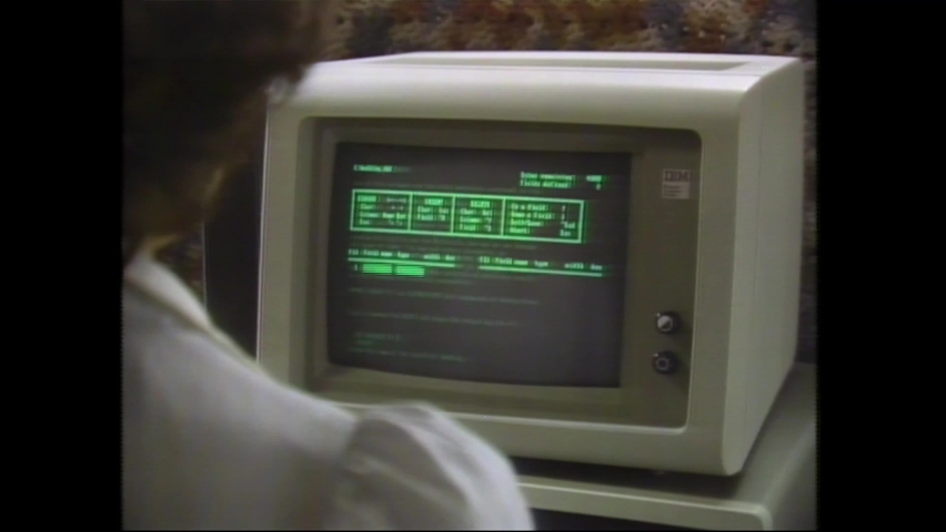 1980s Atlanta, GA Rapid Montage of Vintage Computer Equipment: Green Text or Source Code, Fingers Typing on Keyboard, and close up Floppy Disk Drive. 4K Scan from vintage broadcast VHS Betacam Master 
