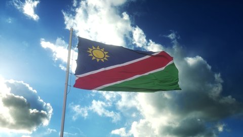 Flag of Namibia waving at wind against beautiful blue sky