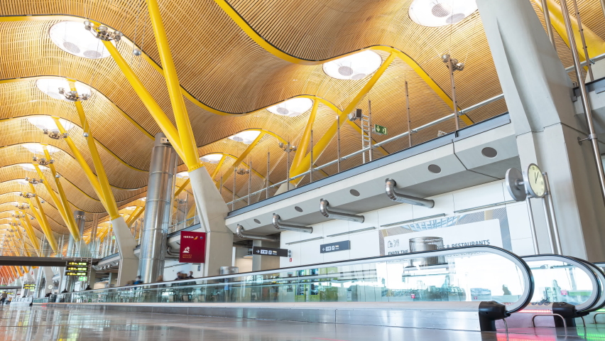 Madrid, Spain- December 30th, 2021: A 4k long exposure time-lapse of passengers traveling through Madrid–Barajas Airport.