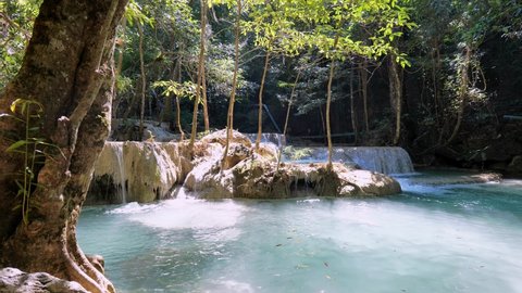 Erawan National Park in Thailand. Erawan Waterfall is a popular tourist destination and famous for its emerald blue water. Deep forest in tropical climate with fantasy atmosphere.