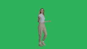 Woman in white t-shirt, jeans and sneakers walking on a Green Screen, Chroma Key. 4k UHD perspective view isolated video.