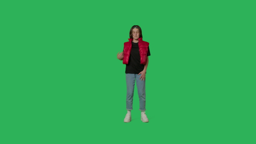 young beautiful girl dancing hip hop, dancehall, street dance over green screen background. Happy smiling child having fun on Chroma Key. 4k uhd video footage Royalty-Free Stock Footage #1084735540
