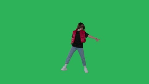 young beautiful girl dancing hip hop, dancehall, street dance over green screen background. Happy smiling child having fun on Chroma Key. 4k uhd video footage