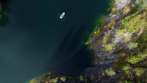 Beautiful nature of Karelia republic. Mountain park Ruskeala. Aerial view from drone to the lake and boat. Aqua colour of water. Russian geographic. Marble quarry canyon.Sight and karelian showplace. 