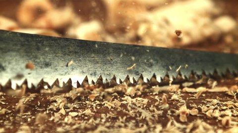 Sawdust falls on the table. On a wooden background. Filmed is slow motion 1000 frames per second.High quality FullHD footage