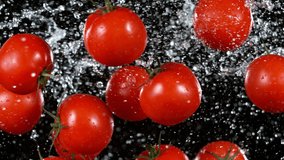 Super Slow Motion Shot of Flying Fresh Tomatoes with Water Splashing on Black Background at 1000fps. - Powered by Shutterstock - Get 15% off with code: PIKWIZARD15