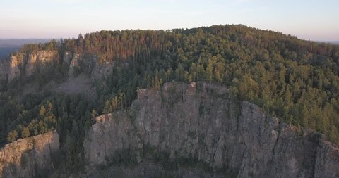 Drone footage of approaching to scenic cliff covered by forest. Aigir rocks at Bashkortostan republic, Russia