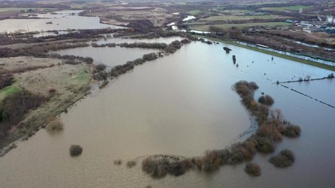 Aerial drone footage of the town of Allerton Bywater near Castleford in Leeds West Yorkshire showing the flooded fields from the River Aire on a rainy winters day during a large flood after a storm.