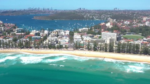 Aerial drone view of the iconic Manly Beach on the Northern Beaches of Sydney, Australia with the North Harbour in the background during summer on a sunny day 