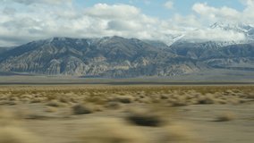 Road trip to Death Valley, driving auto in California, USA. Hitchhiking traveling in America. Highway, mountains and dry desert, arid climate wilderness. Passenger POV from car. Journey to Nevada. - Powered by Shutterstock - Get 15% off with code: PIKWIZARD15