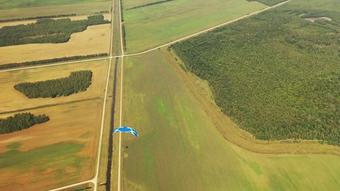 drone filming of a hang-glider flight over Belarusian fields