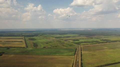 drone filming of a hang-glider flight over Belarusian fields
