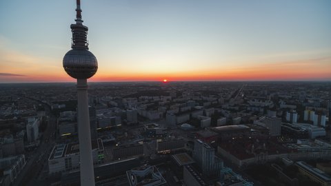 Berlin, Germany - circa 2021 - Establishing Aerial View Shot of Berlin, Germany, capital city, sun just came up over horizon, TV Tower, Alexander Platz, sunrise, early morning