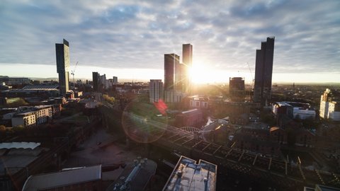 Establishing Aerial View Shot of Manchester, City Skyline, England United Kingdom, beautifully shining light, flying low