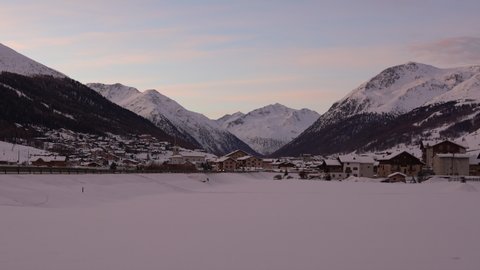 Livigno, Italy - December 29, 2021 - morning view of the ski resort of Livigno with mountains in the background at sunrise