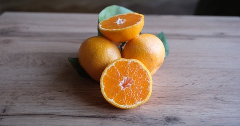 ripe and juicy tangerine (mandarin). cutaway tangerine fruit on a gray background.