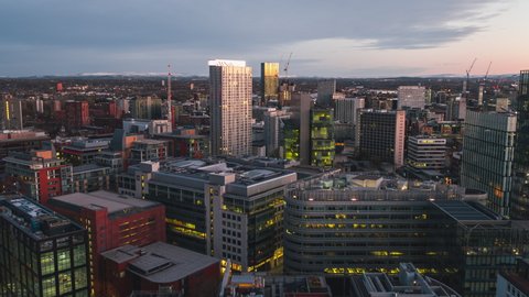 Manchester, Great Britain - circa 2021 - Establishing Aerial View Shot of Manchester, City Skyline, England United Kingdom, city center, office buildings, morning