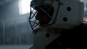 HANDHELD Portrait of the hockey goalie posing inside the indoor ice rink. Shot with 2x anamorphic lens - Powered by Shutterstock - Get 15% off with code: PIKWIZARD15