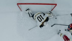 OVERHEAD HIGH ANGLE Goalie makes a save after the shot during the hockey game. Shot with 2x anamorphic lens - Powered by Shutterstock - Get 15% off with code: PIKWIZARD15